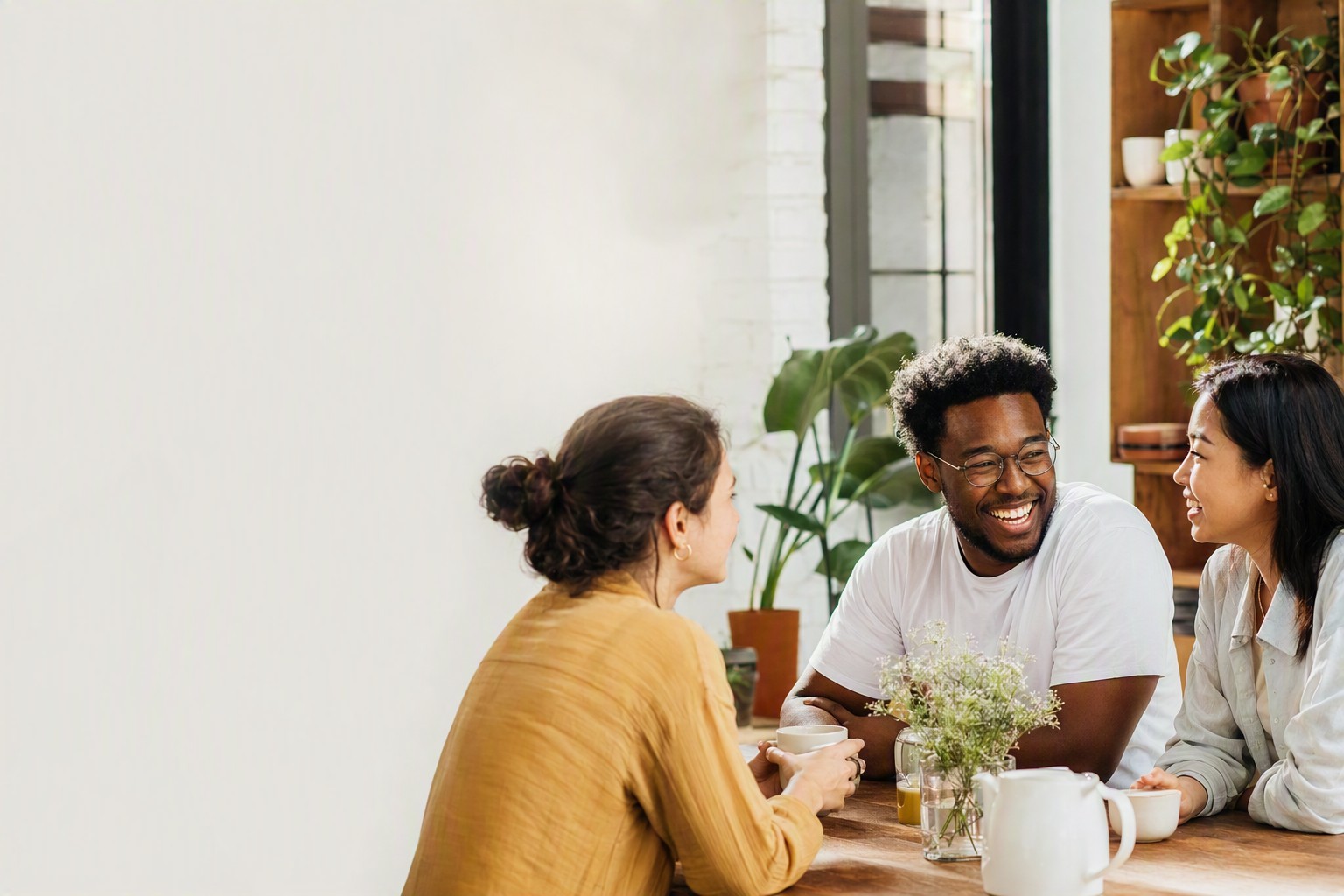 Two new friends laughing over coffee after matching on an app made for friendship, not dating
